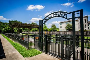 a gate that says hong park with a building and trees in the background